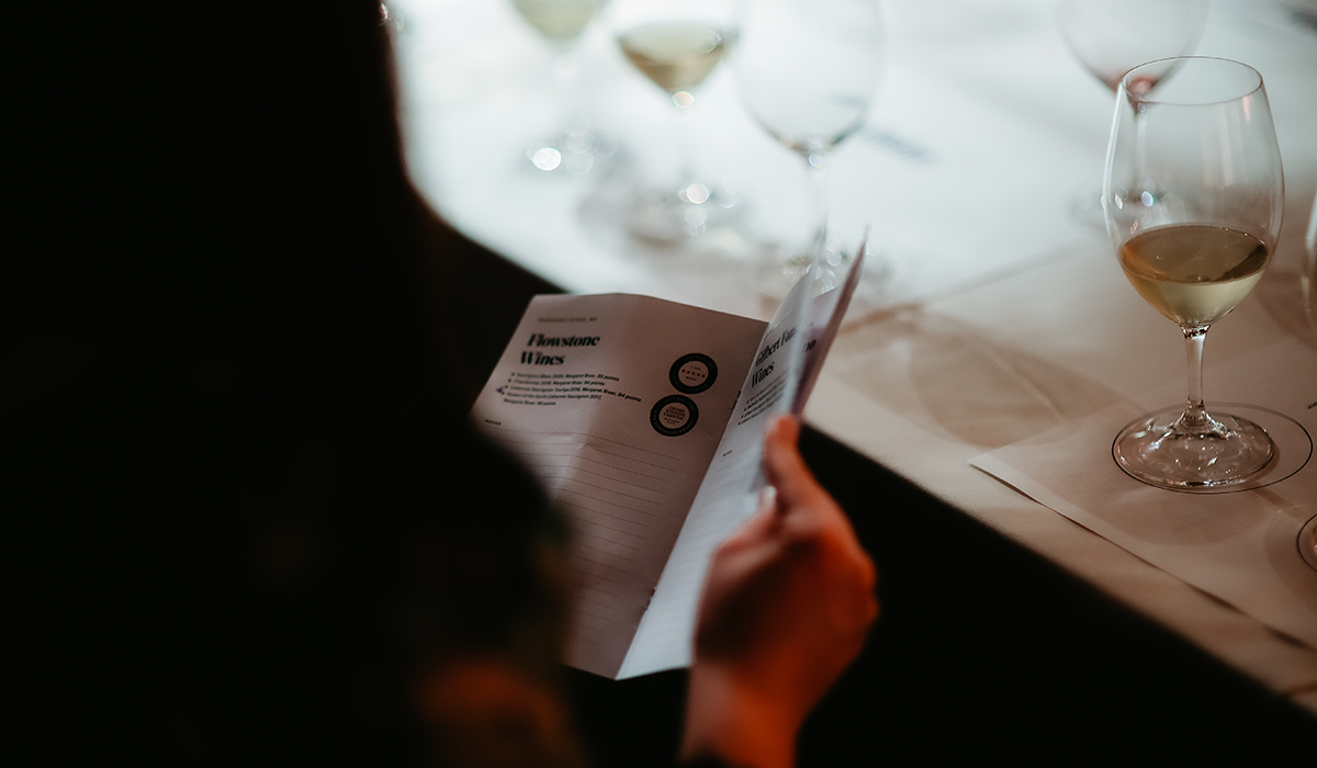 Guest reading a booklet at a Halliday sip series event.