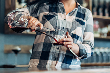 RIEDEL decanter filled with red wine being poured into RIEDEL glassware