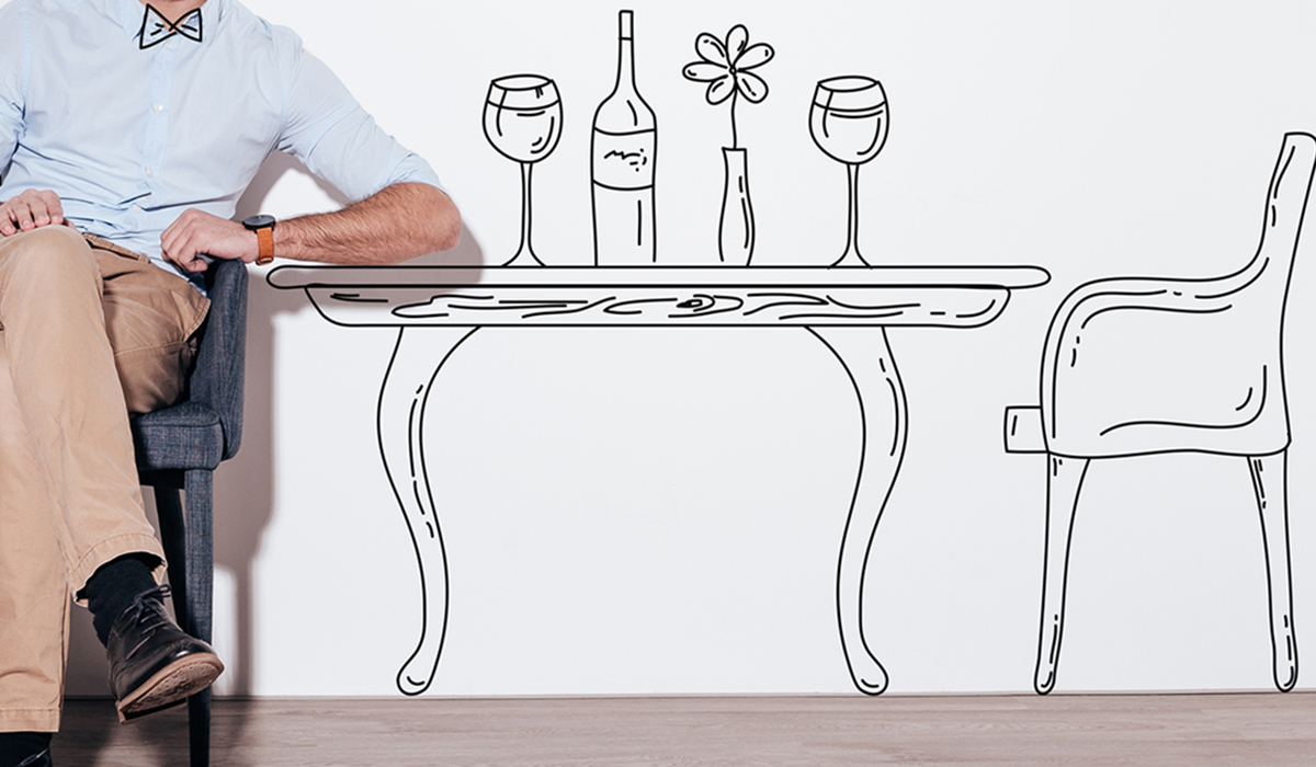 Man sitting in a chair against illustration of dining table in the background