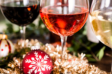 Red, pink and white wine with Christmas decorations