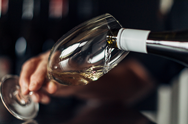 White wine being poured into a glass