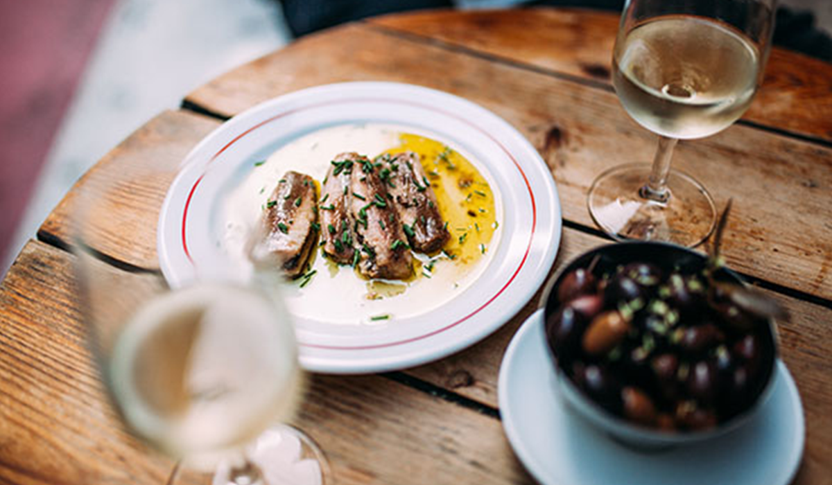 Fish and olives with two glasses of sauvignon blanc