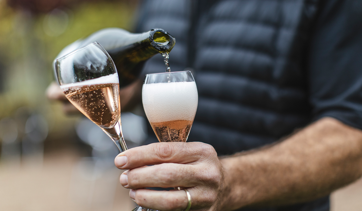 Sparkling rose being poured into two glasses