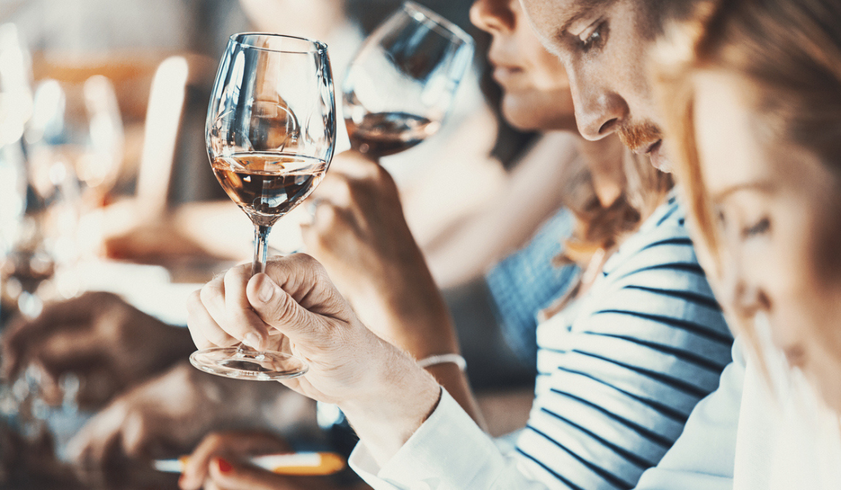 Students smelling and tasting wine in a classroom