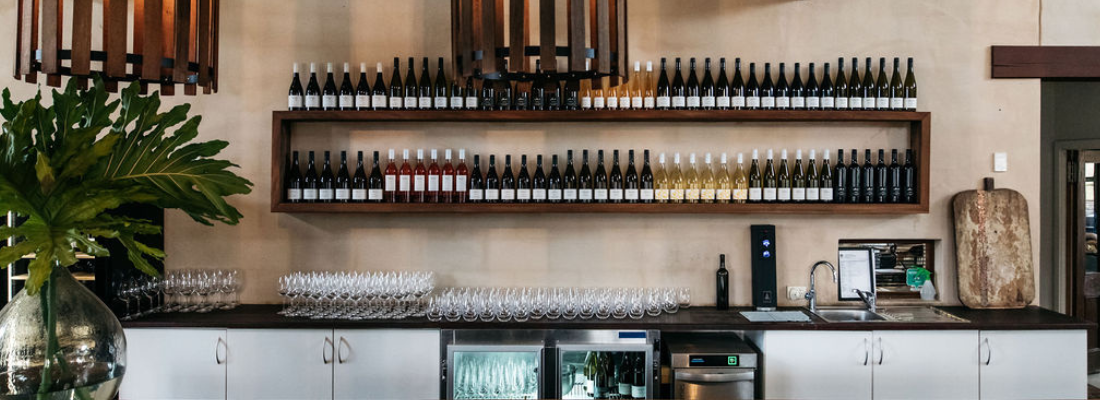 Wine bottles on shelf. 