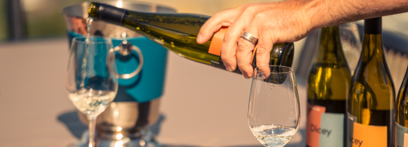 A glass and display of Dicey wines 