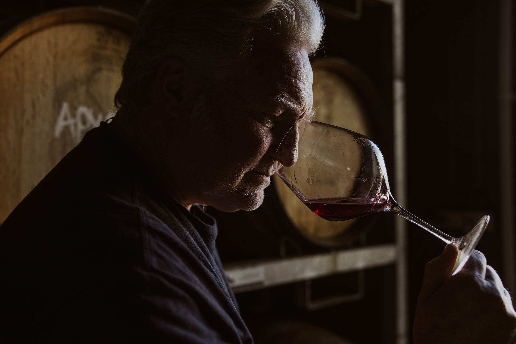 Man smelling wine from glass